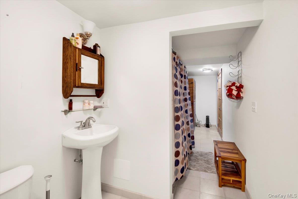 161 Goldens Bridge Road Katonah, NY 10536 - Photo 34 of 44 a bathroom with a sink and mirror with toilet