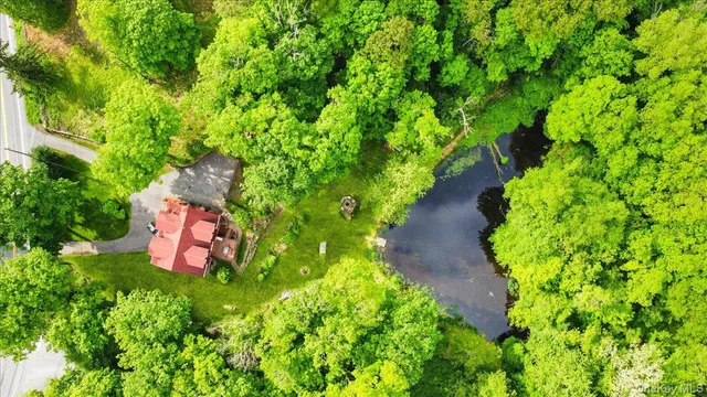 a kitchen with stainless steel appliances a stove a refrigerator a kitchen island dining table and chairs