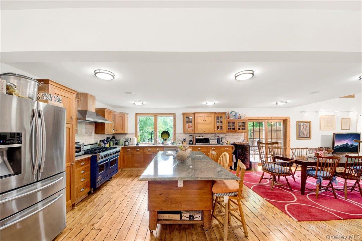 161 Goldens Bridge Road Katonah, NY 10536 - Photo 5 of 44 a kitchen with stainless steel appliances a stove a refrigerator a kitchen island dining table and chairs