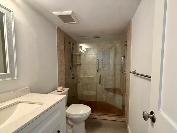 a bathroom with a shower and a toilet