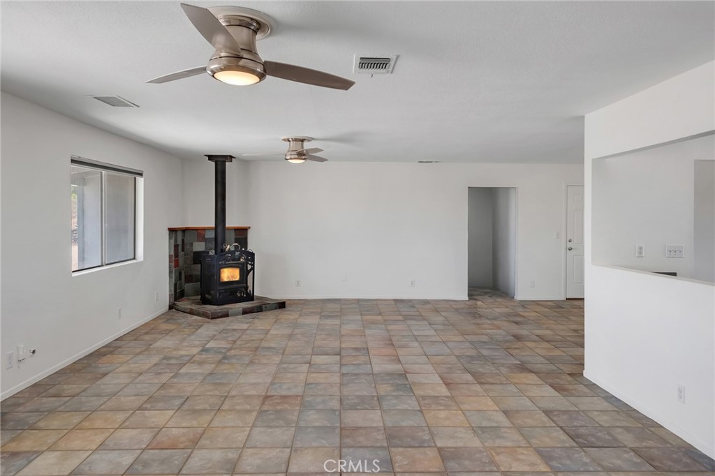 12736 Oasis Road Pinon Hills, CA 92372 - Photo 5 of 33 a view of an empty room with a fireplace