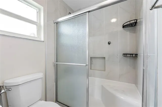 a bathroom with a shower and a toilet