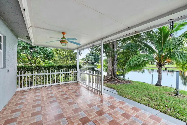 a view of a porch with a floor to ceiling window and a yard