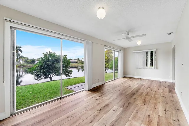a view of a room with wooden floor and outdoor view