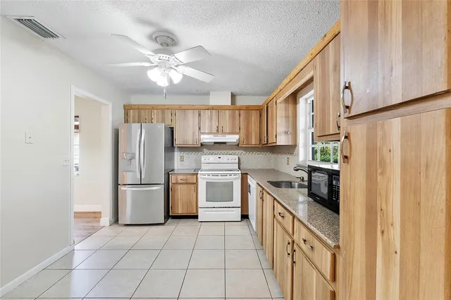 a kitchen with a refrigerator a sink and dishwasher