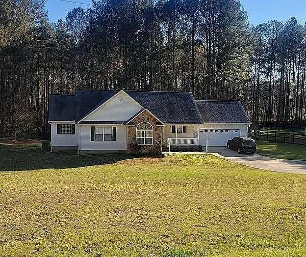 1257 Wagers Mill Road Newnan, GA 30263 - Photo 1 of 1 a front view of house with yard and trees in the background