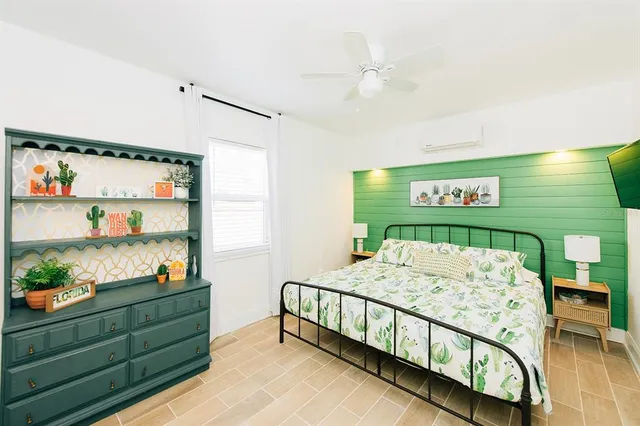 a bedroom with furniture and a window