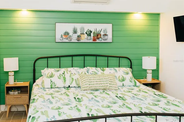 a bed with a white comforter and pillows