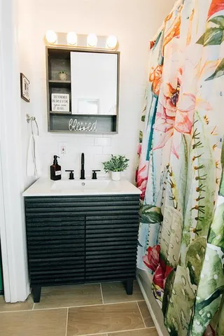 a bathroom with a sink and a mirror