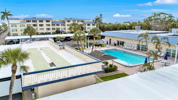 a view of a swimming pool with outdoor seating and city view