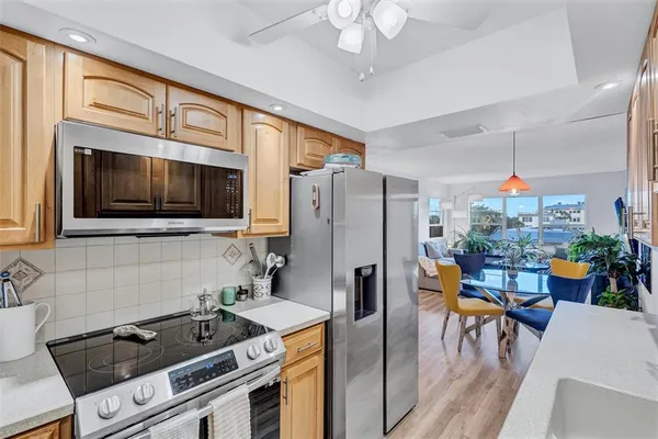 a kitchen with a refrigerator a stove and a microwave