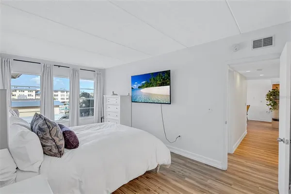 a bedroom with a bed and a flat screen tv