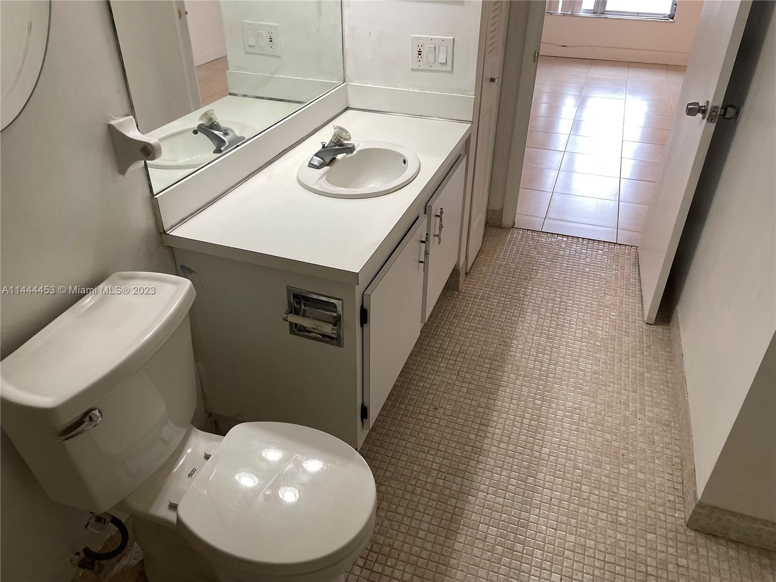 Inverrary Lauderhill, FL 33319 - Photo 11 of 23 a bathroom with a sink mirror vanity and toilet