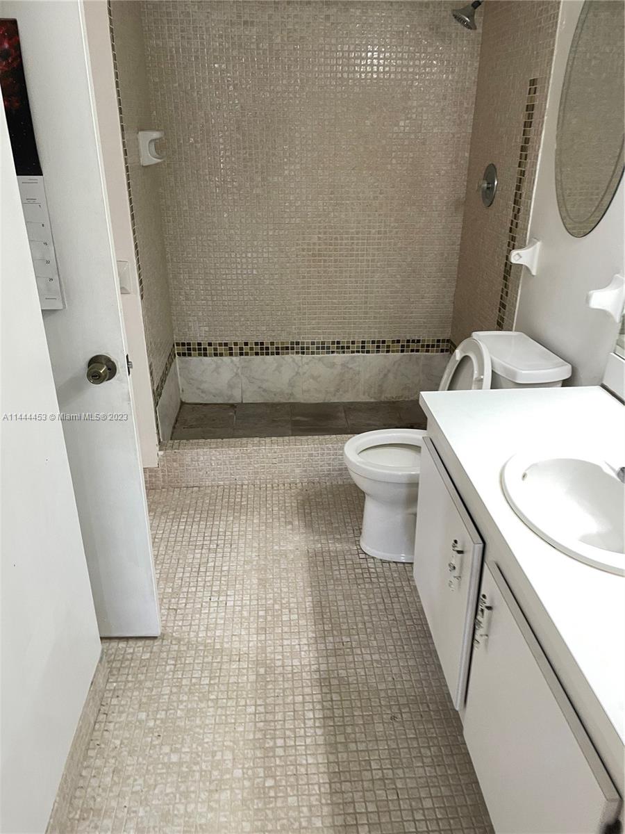 Inverrary Lauderhill, FL 33319 - Photo 12 of 23 a bathroom with a sink a toilet and a mirror