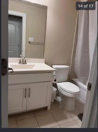a bathroom with a sink a toilet a mirror and shower