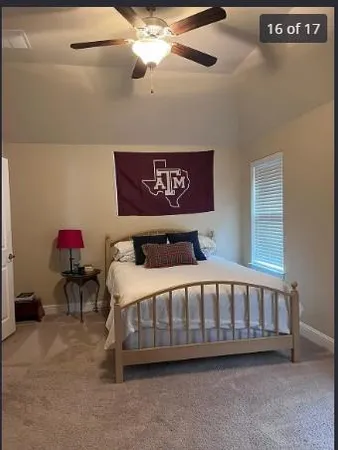 a bed sitting in a bedroom next to a window