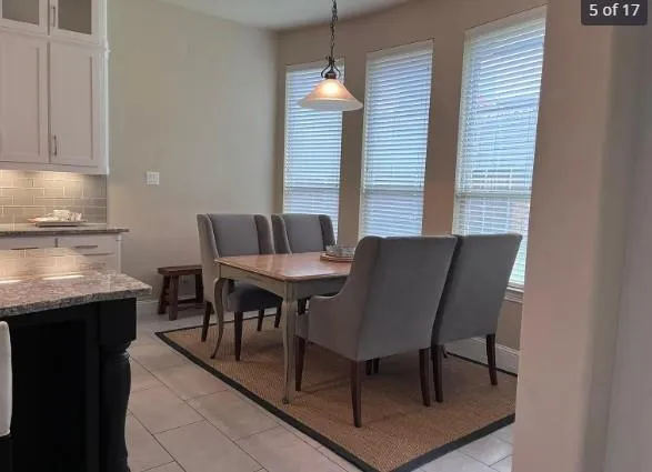 a dining room with furniture and window