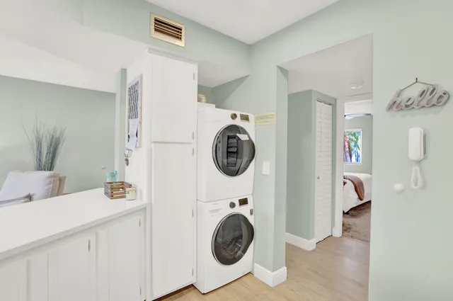 a utility room with sink dryer and washer