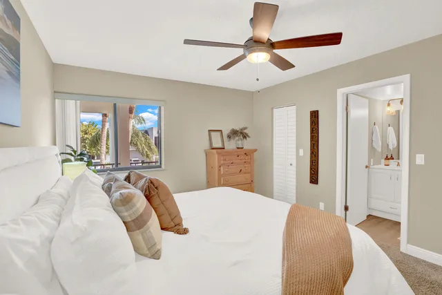 a bedroom with a large bed and a chandelier