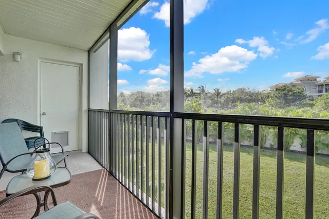 a view of a balcony with chair and wooden floor