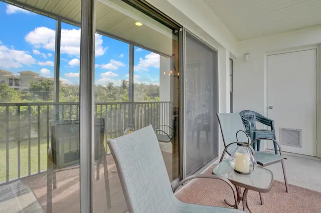 a balcony with table and chairs
