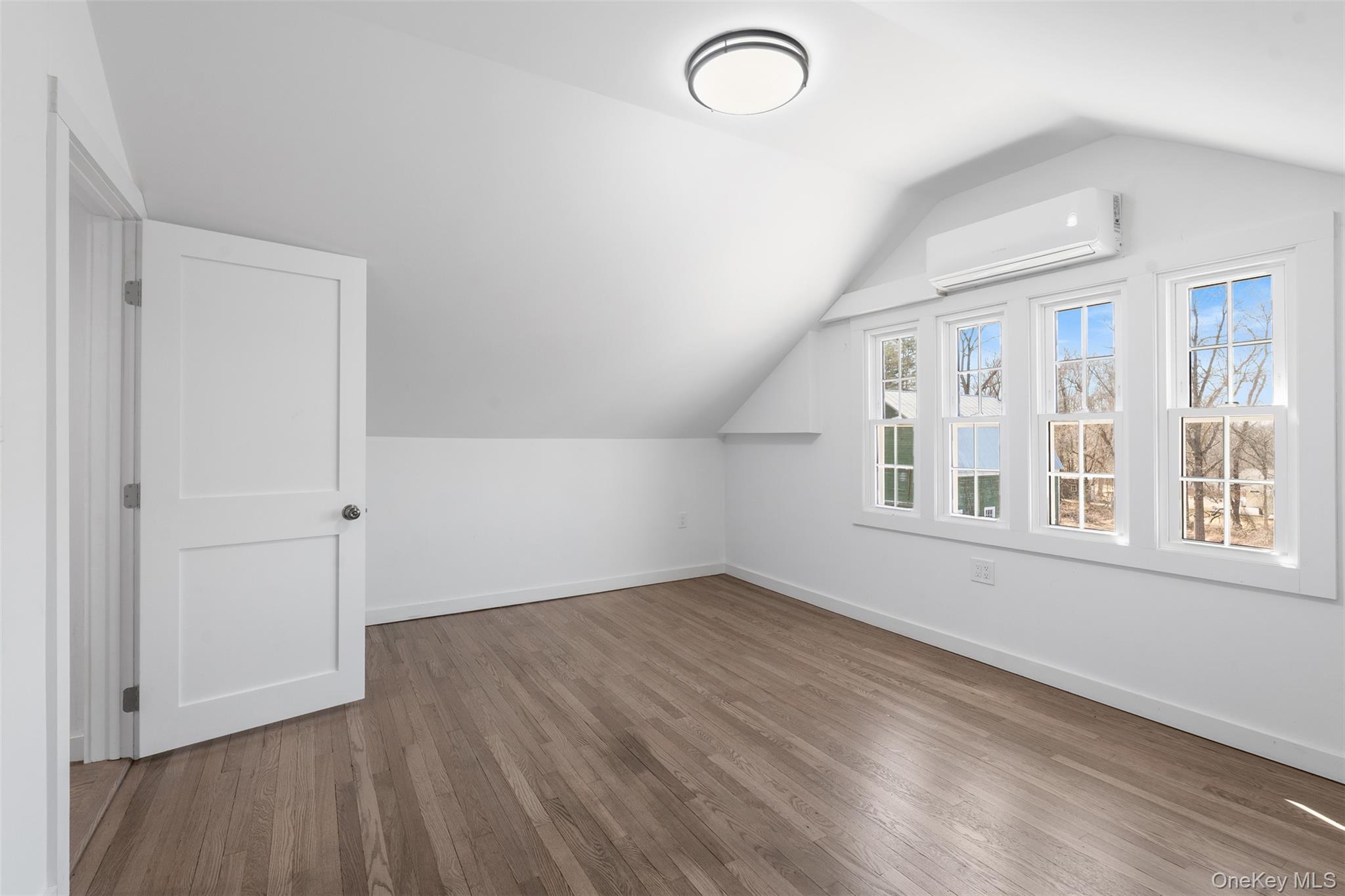 70 Barmore Road LaGrangeville, NY 12540 - Photo 27 of 47 Additional living space featuring a wall mounted air conditioner, lofted ceiling, and wood finished floors