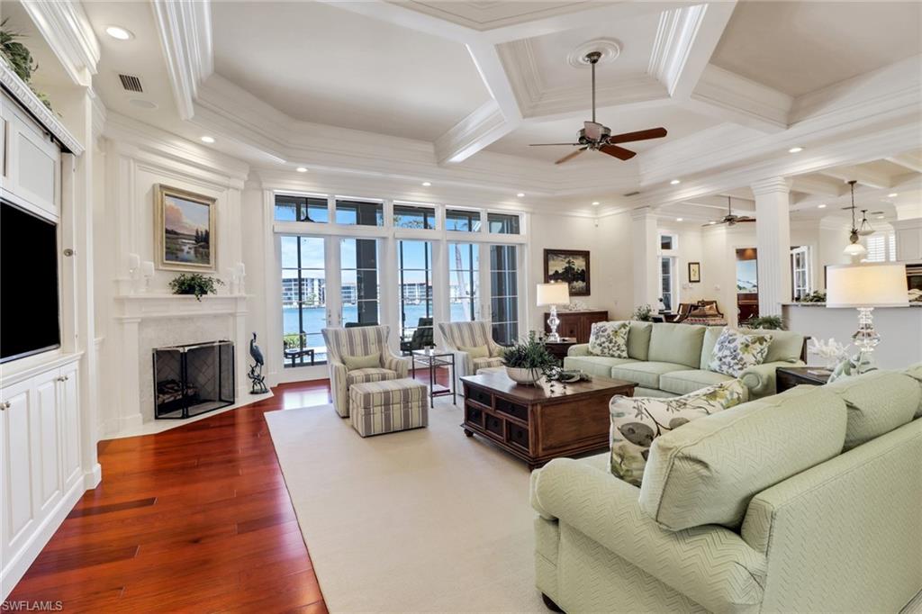 2621 Windward Way Naples, FL 34103 - Photo 12 of 37 a living room with furniture fireplace and flat screen tv