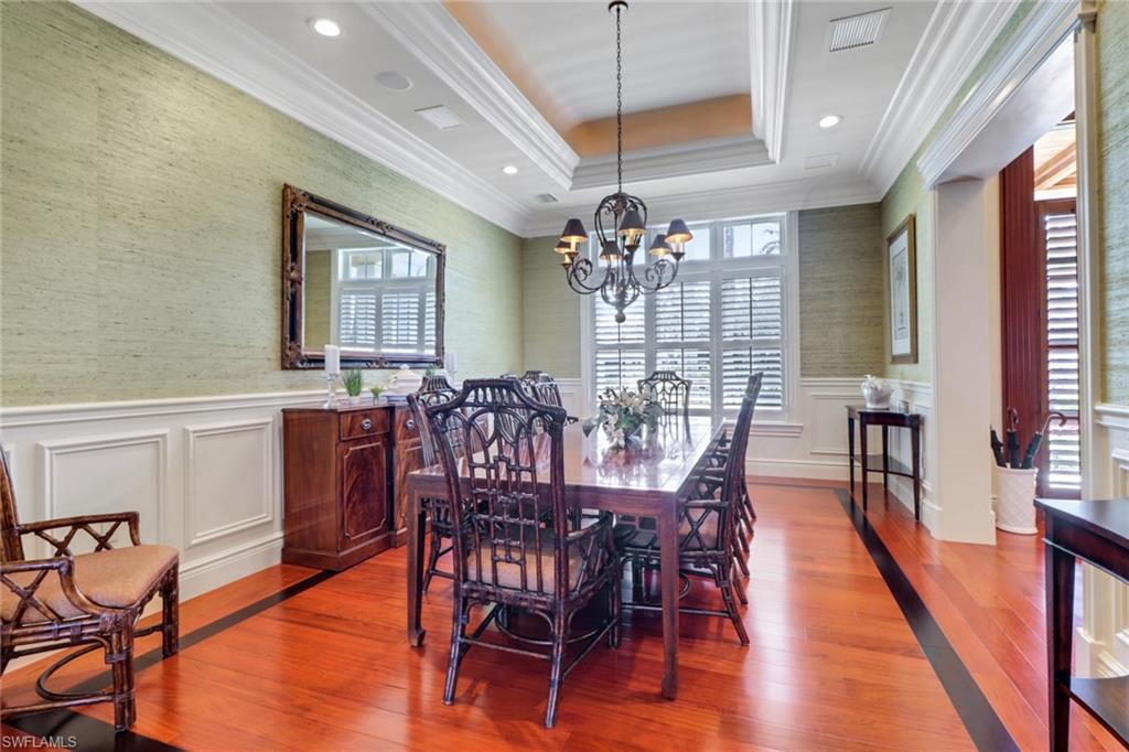 2621 Windward Way Naples, FL 34103 - Photo 13 of 37 a view of a dining room with furniture and chandelier