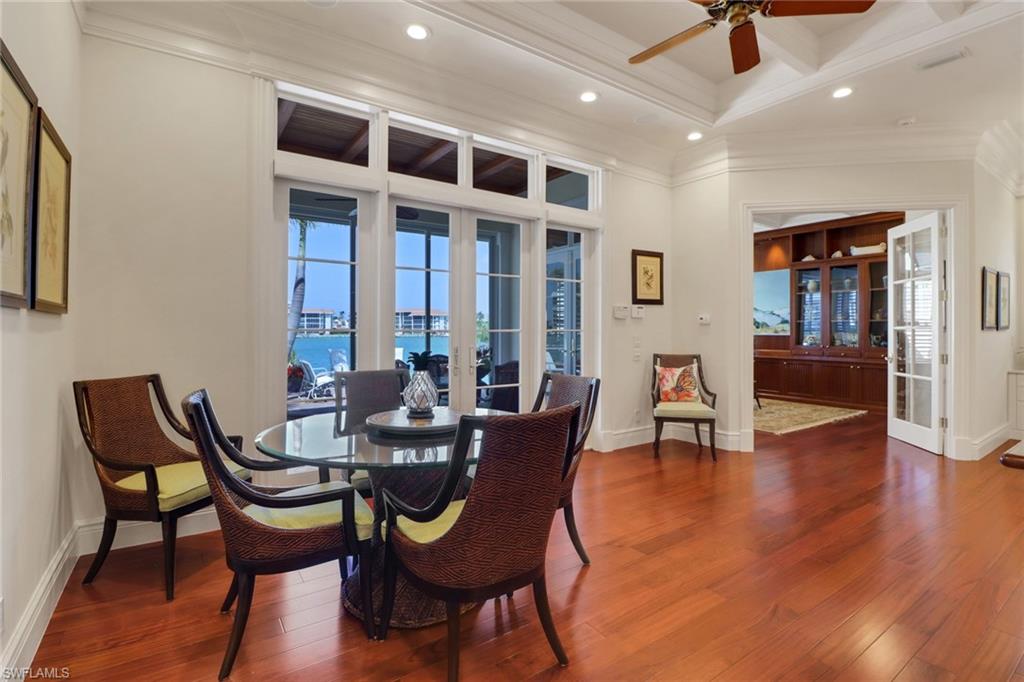 2621 Windward Way Naples, FL 34103 - Photo 14 of 37 a dining room with furniture and wooden floor