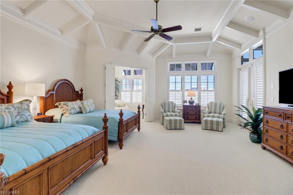 2621 Windward Way Naples, FL 34103 - Photo 15 of 37 a bedroom with bed couch and window