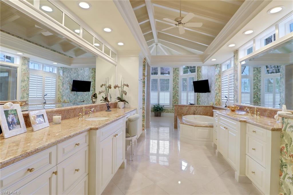 2621 Windward Way Naples, FL 34103 - Photo 17 of 37 a bathroom with a granite countertop sink mirror and bathtub