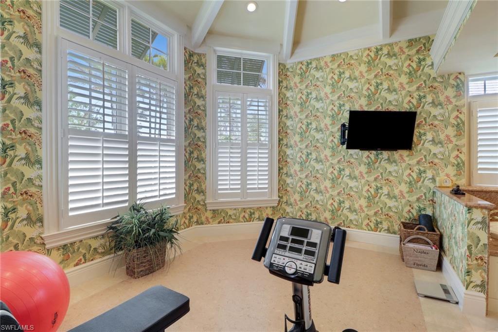 2621 Windward Way Naples, FL 34103 - Photo 18 of 37 a living room with furniture and a flat screen tv