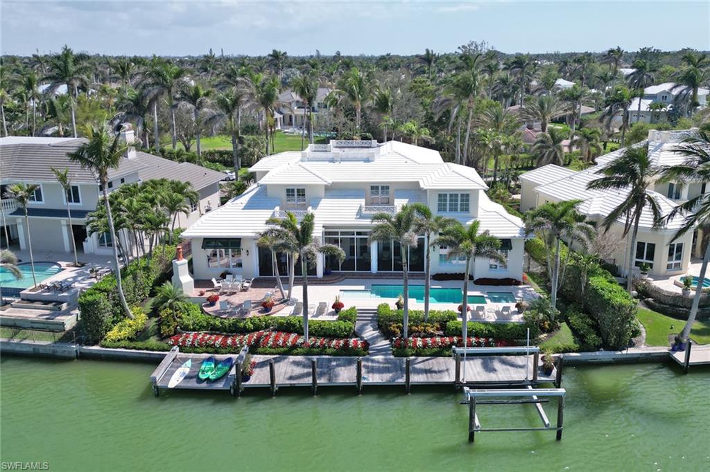 2621 Windward Way Naples, FL 34103 - Photo 2 of 37 an aerial view of a house with a garden and outdoor seating