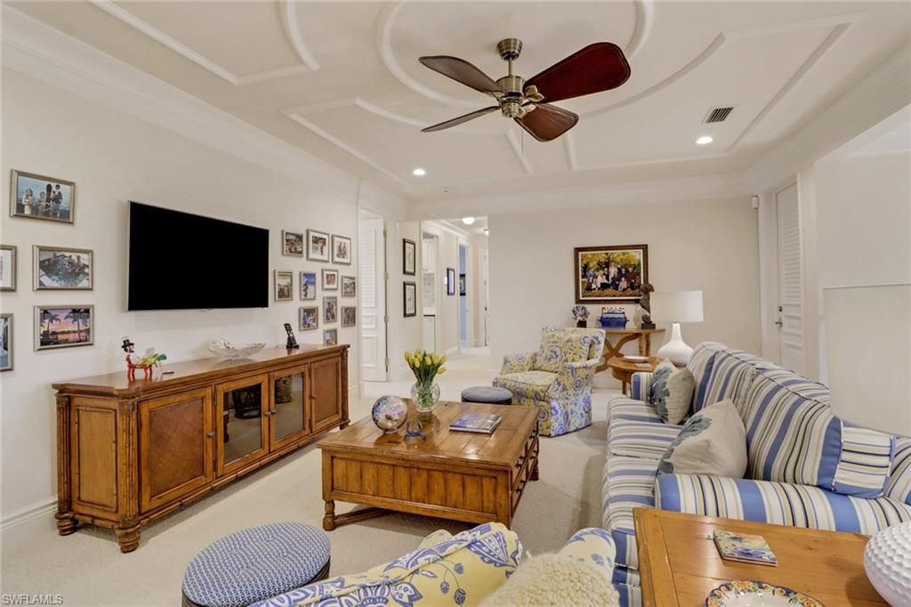 2621 Windward Way Naples, FL 34103 - Photo 21 of 37 a living room with furniture kitchen view and a flat screen tv