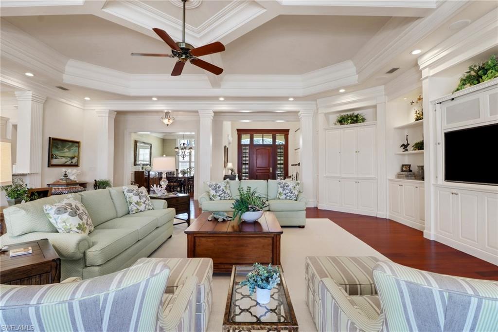 2621 Windward Way Naples, FL 34103 - Photo 22 of 37 a living room with furniture a flat screen tv and a view of kitchen