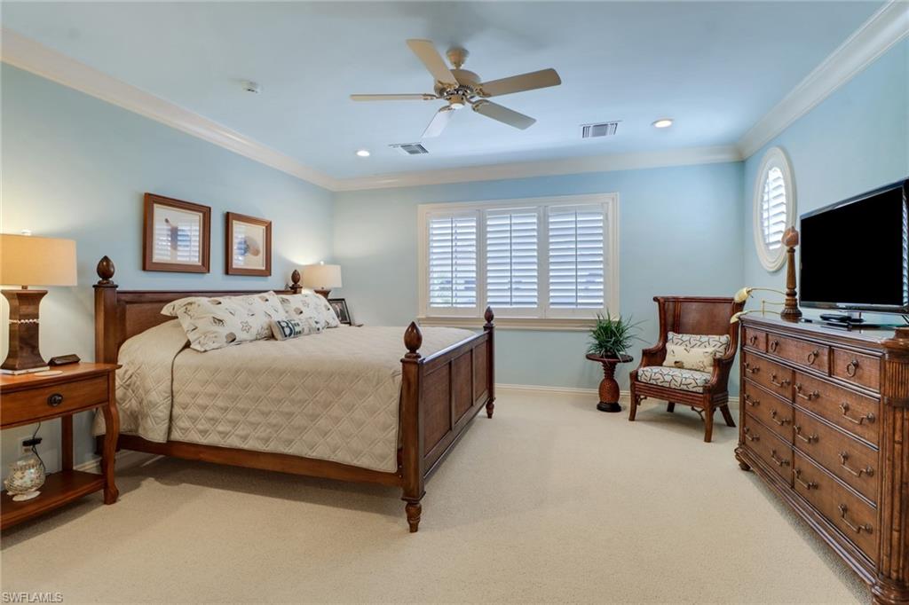 2621 Windward Way Naples, FL 34103 - Photo 23 of 37 a bed room with furniture and a flat screen tv