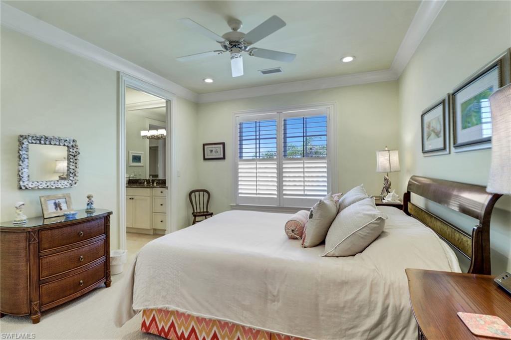 2621 Windward Way Naples, FL 34103 - Photo 27 of 37 a bedroom with a bed and a dresser