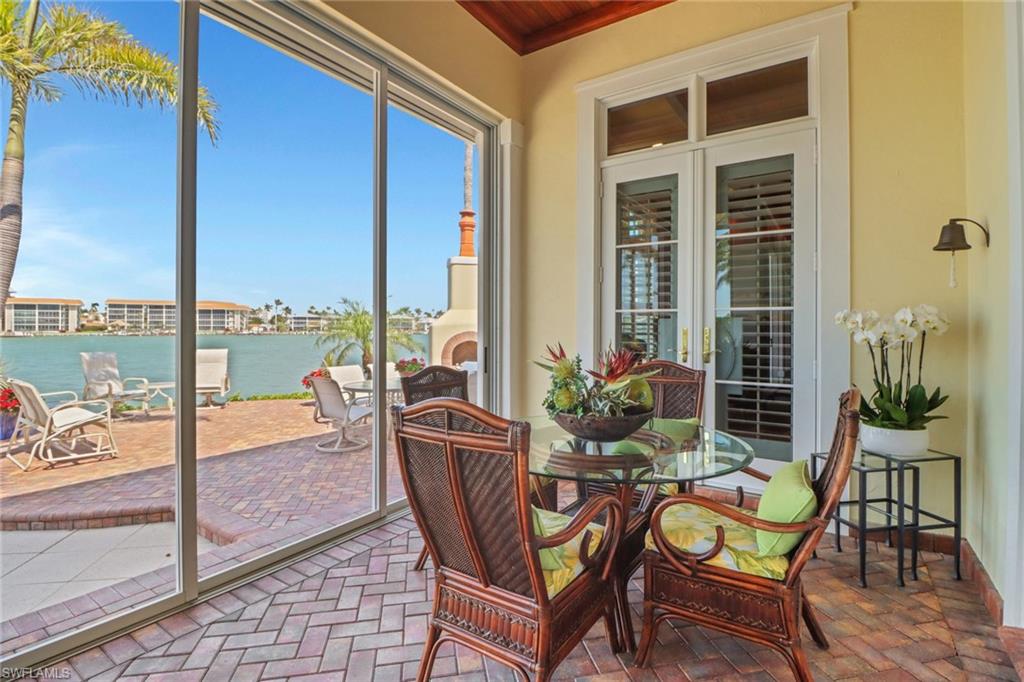 2621 Windward Way Naples, FL 34103 - Photo 30 of 37 a view of a swimming pool with chairs