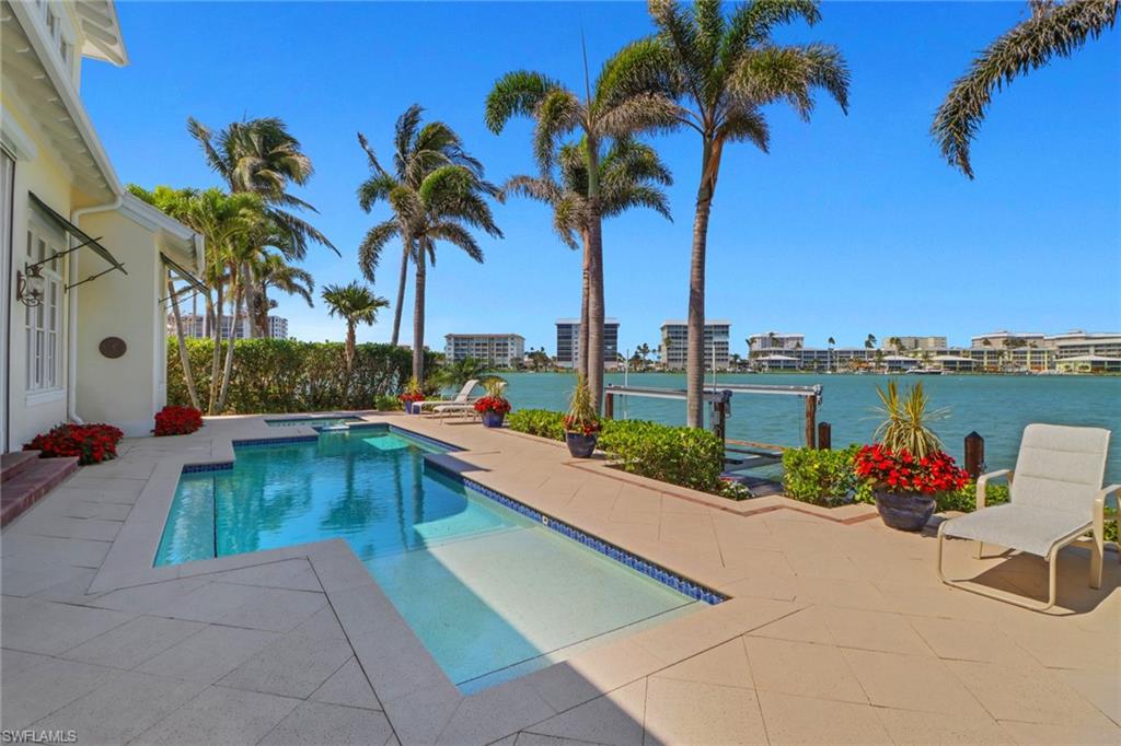 2621 Windward Way Naples, FL 34103 - Photo 33 of 37 a view of swimming pool with outdoor seating and plants