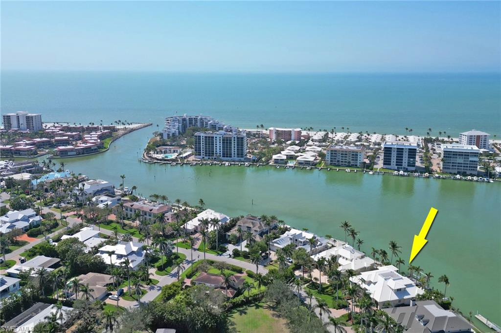 2621 Windward Way Naples, FL 34103 - Photo 4 of 37 a view of a lake with houses