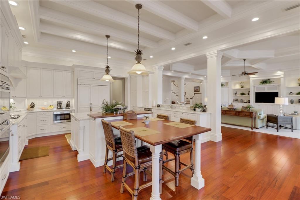 2621 Windward Way Naples, FL 34103 - Photo 9 of 37 a view of a dining room with furniture and wooden floor