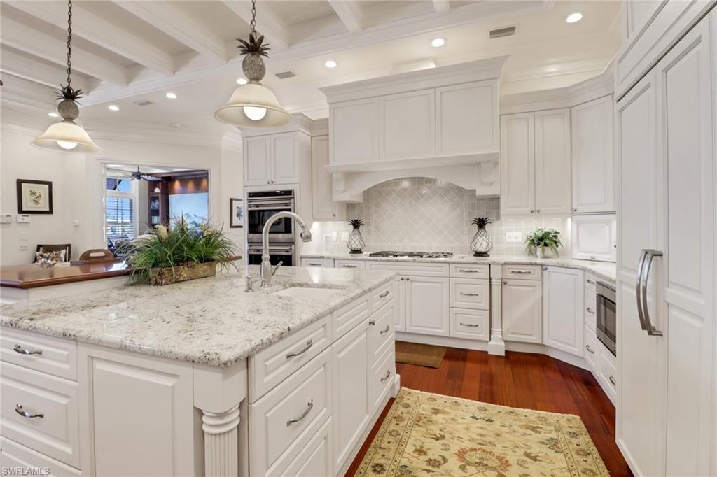2621 Windward Way Naples, FL 34103 - Photo 10 of 37 a kitchen with white cabinets and sink