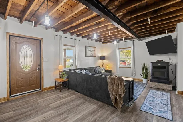a living room with furniture a flat screen tv and a table
