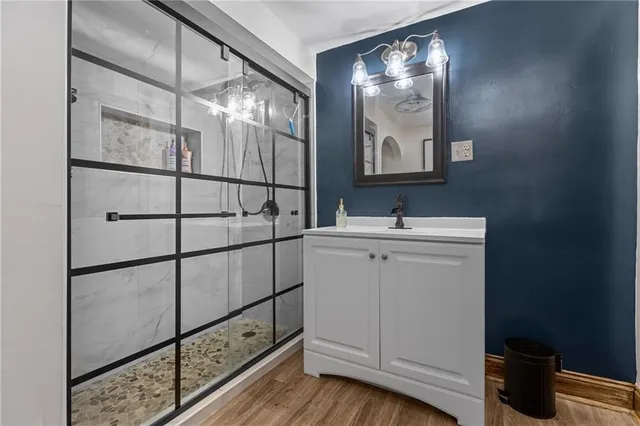 a bathroom with a sink mirror and vanity