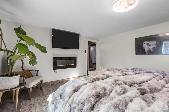 a bedroom with a bed and a television