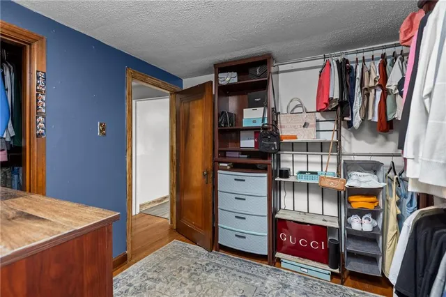 a view of walk in closet and bedroom