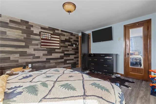 a bedroom with a bed and a television