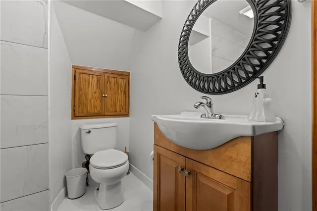 a bathroom with a sink mirror and toilet
