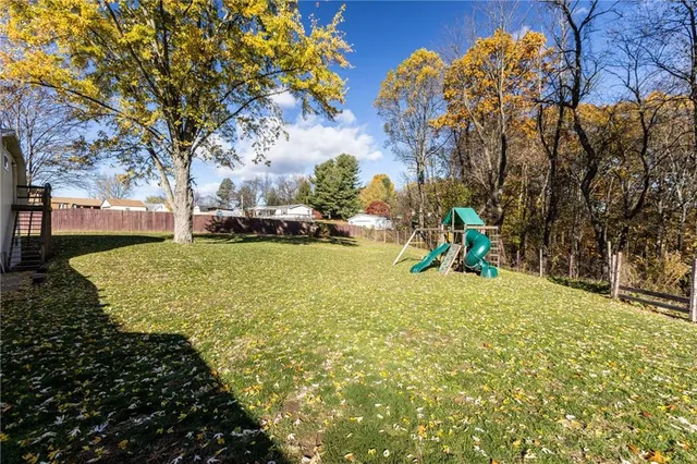 a view of a yard with large trees