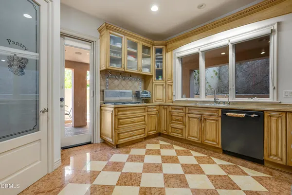a kitchen with stainless steel appliances granite countertop a refrigerator and a sink
